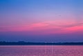 An aircraft approaching airport glides over Ambazari lake Nagpur with a backdrop of Sunset on a beautiful evening. Royalty Free Stock Photo