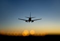 Aircraft approaching airport at sunset Royalty Free Stock Photo