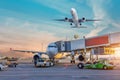 Aircraft is attached to the terminal gangway of the airport building preparation for towing and launch flight in the evening at Royalty Free Stock Photo