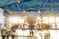 Aircraft in the aviation industrial hangar on maintenance, outside the gate bright light