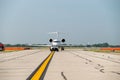 Aircraft being guided by a car on a runway of an airport Royalty Free Stock Photo