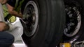 Aircraft brake repair. Close up of airplane wheel and shaft. Huge airplane tyre with shaft and landing gear of plane