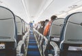 Aircraft cabin after take off. inside the plane. passengers sit on the seat in the cabin ECOM class in Boeing. the passage between Royalty Free Stock Photo