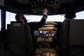 Aircraft captain pushing dashboard handle in plane cockpit