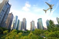 Aircraft flying over the modern city buildings over