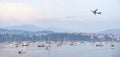 Aircraft flying over the sailboats and Hendaye, a French village located on the coast of France