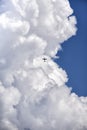 Aircraft in front of the huge white cumulus cloud