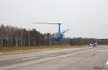 Aircraft - Blue small helicopter makes flight at low height front view