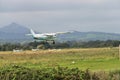 Aircraft G-FFEN landing in Newcastle Aerodrome Leamore Upper Co. Wicklow Ireland. The Greta Sugar Loaf Mountain in background Royalty Free Stock Photo