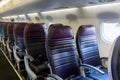 Aircraft interior. The cabin of modern passenger plane. Aircraft seats and window. Royalty Free Stock Photo