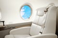 Aircraft (jet) business class interior with porthole Royalty Free Stock Photo