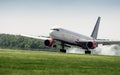 White passenger aircraft landing on airport runway. Royalty Free Stock Photo