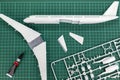 Aircraft layout assembly,  model   plane building on wooden table with scale modelling tools Royalty Free Stock Photo