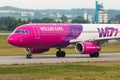 Aircraft line Wizzair taxiing on the airport runway.