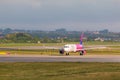 Aircraft line Wizzair taxiing on the airport runway.