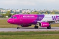 Aircraft line Wizzair taxiing on the airport runway.