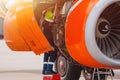 Aircraft Maintenance Mechanics Inspecting and Working on Airplane Jet Engine on Apron. Royalty Free Stock Photo