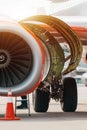 Aircraft Maintenance Mechanics Inspecting and Working on Airplane Jet Engine on Apron. Royalty Free Stock Photo