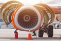 Aircraft Maintenance Mechanics Inspecting and Working on Airplane Jet Engine on Apron. Royalty Free Stock Photo