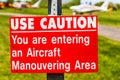 Aircraft manouvering red and white warning sign hung on post at airstrip. Royalty Free Stock Photo