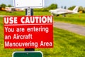 Aircraft manouvering red and white warning sign hung on post at airstrip. Royalty Free Stock Photo