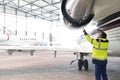 Aircraft mechanic/ ground crew inspects and checks the turbine Royalty Free Stock Photo