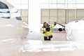 Aircraft mechanic inspects and checks the technology of a jet in a hangar at the airport Royalty Free Stock Photo