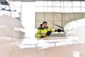 Aircraft mechanic inspects and checks the technology of a jet in Royalty Free Stock Photo