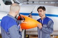 Aircraft mechanics holding propeller