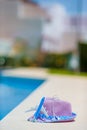 Aircraft model and straw purple hat near swimming pool at summer Royalty Free Stock Photo