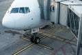 Aircraft with passage corridor/tunnel being prepared for departure from an international airport Royalty Free Stock Photo