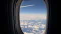 Aircraft porthole. Airplane flight, window view. Wing, blue sky and white clouds