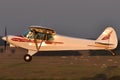 Aircraft, Instruction aircraft in red and white color on takeoff at local airport. side view Royalty Free Stock Photo