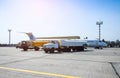 Aircraft refueling with a high pressure tanker. A passenger jet is being refueled from a supply truck. Airport Service