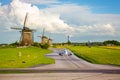 Aircraft on a runway with windmills,herd of sheep under blue sky and clouds Royalty Free Stock Photo