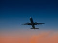 Aircraft take-off from airport at sunset time. Air transportation and overnight flight theme Royalty Free Stock Photo