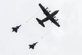 Aircraft tanker during refueling two fighter jets.