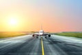 Aircraft taxis after landing in the evening at sunset at the airport. Royalty Free Stock Photo