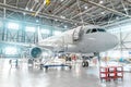 Aircraft under maintenance, checking mechanical systems for flight operations. Plane in the hangar