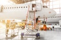 Aircraft is under repair, technical inspection is a working technician. A view of the nose, a cockpit of pilots with a staircase l