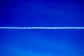 Aircraft Vapour Trail Across a Clear Blue Sky Royalty Free Stock Photo