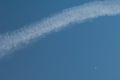 Aircraft vapour trail and moon in the sky of Gran Canaria. Royalty Free Stock Photo