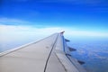 Aircraft wing, cloud and clear sky