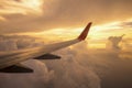 Aircraft wing on the clouds of sunset ,flying traveling background