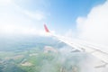 Aircraft wing flying view from window of nature in the morning.