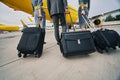 Aircrew with their baggage walking towards the landed airplane