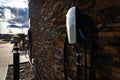 Tesla level 2 chargers mounted on a brick wall for EV charging