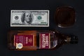 Hankey Bannister blended Scotch whisky bottle, glass and pile of 100 dollar bills