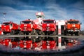 Airfield fire trucks with reflection in a puddle Royalty Free Stock Photo