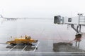 Airfield with a sleeve for getting on a plane on a rainy day. Travel and leisure Royalty Free Stock Photo